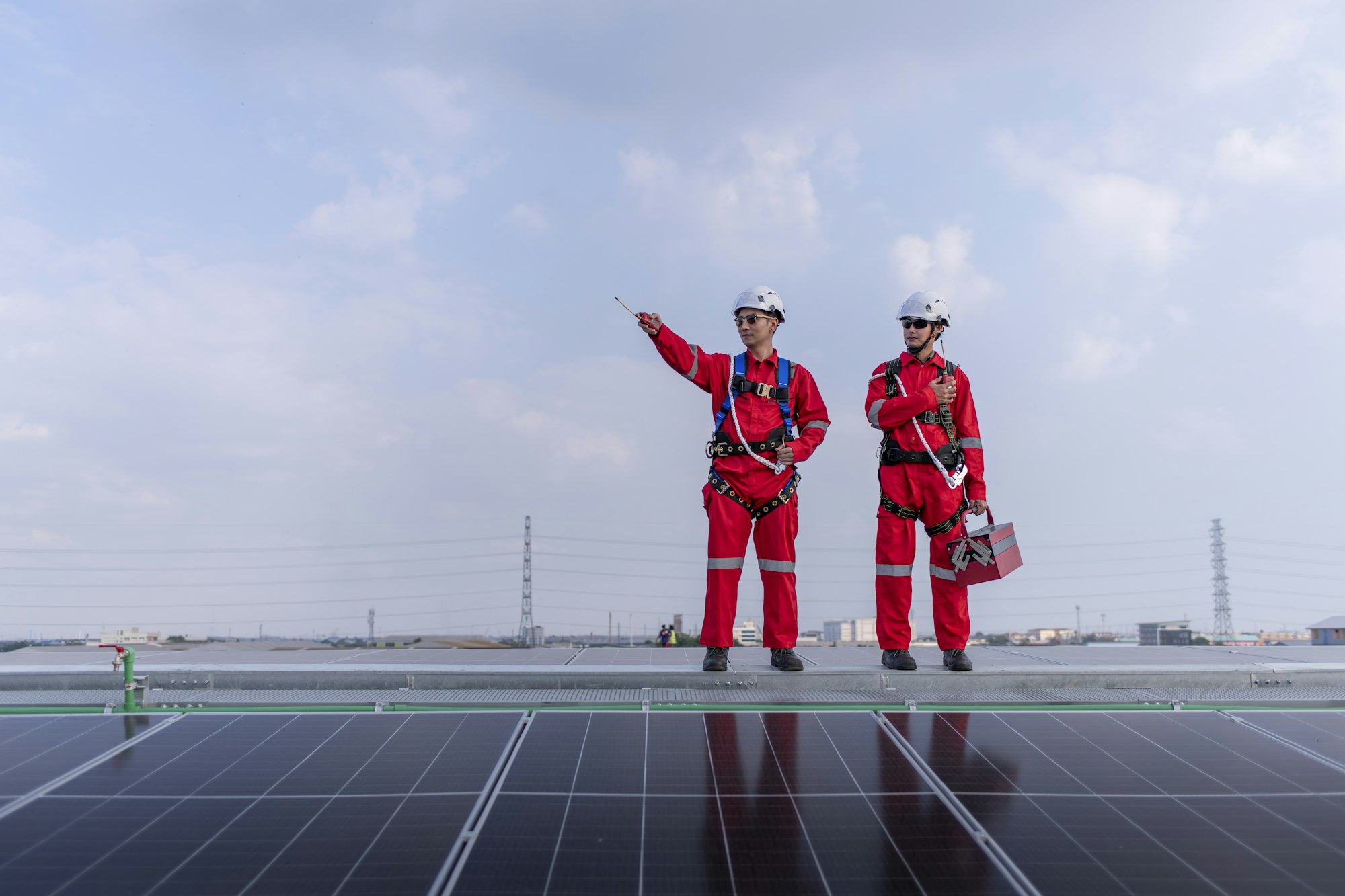 Engineers work and holding box on factory roof inspection survey and check solar cell panel .Solar c
