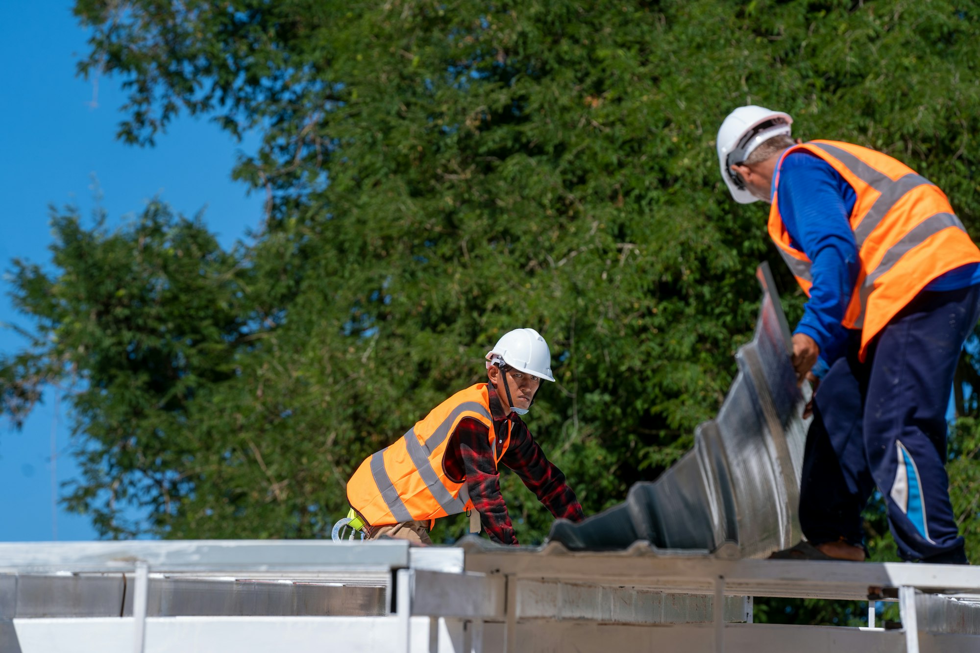 The Roofer technicians work and installing new roof structure on top roof.