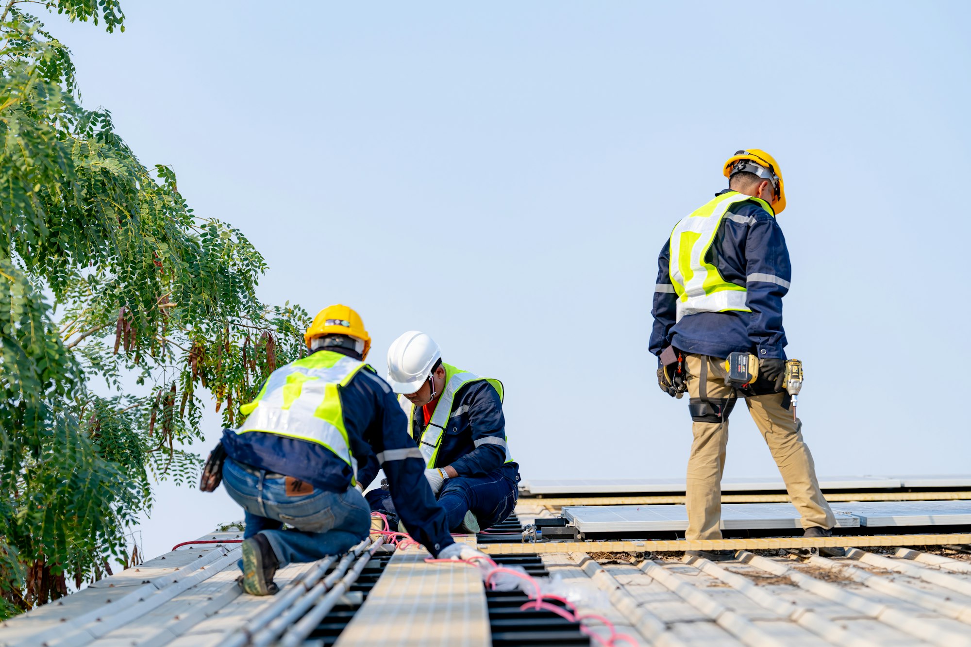 workers installing solar panels, for efficient energy on rooftop